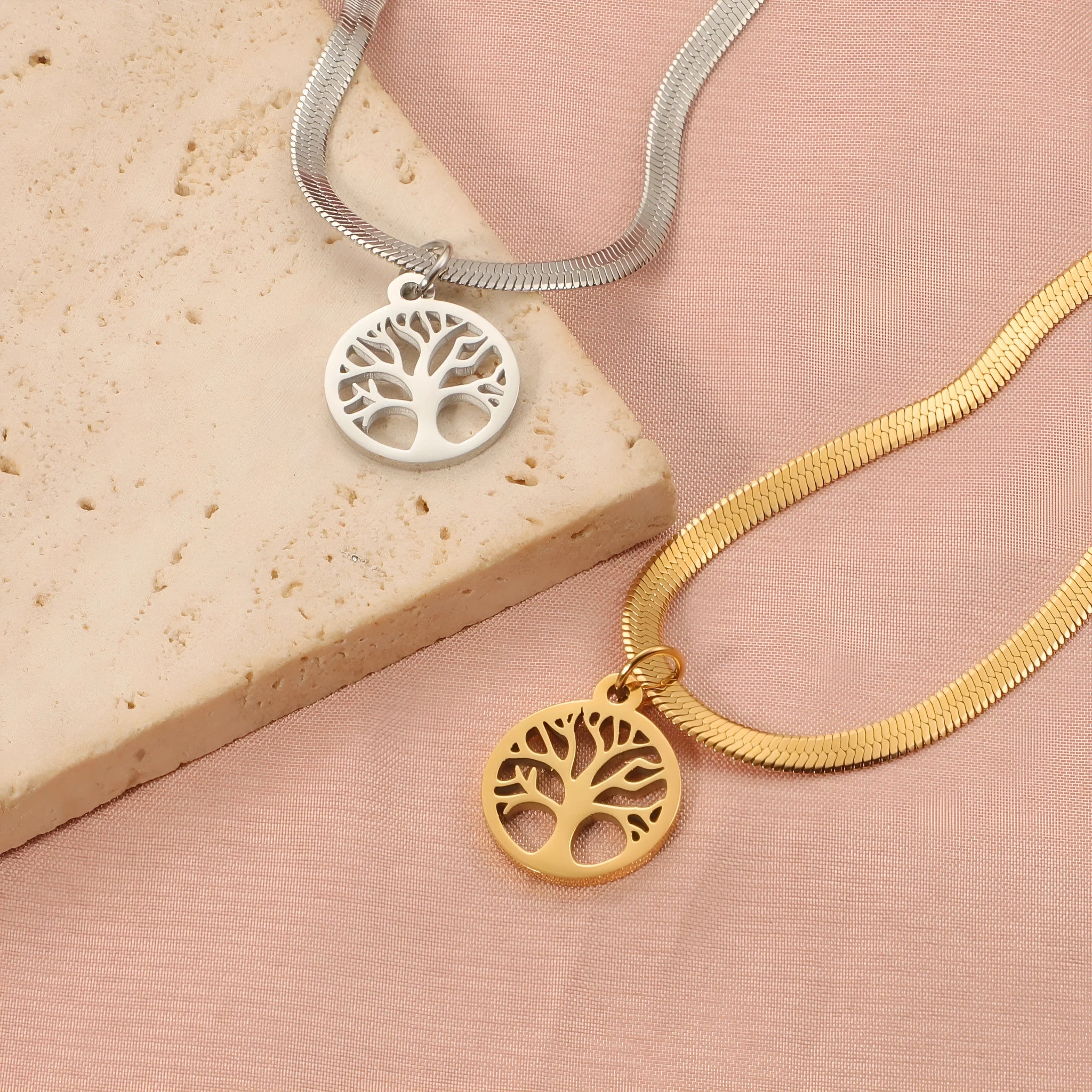 Stainless steel adjustable lucky tree necklace with a snake bone chain on a white background.