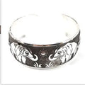 Ethnic carved open Miao silver bracelet with Roman patterns showing elephant and turtle motifs