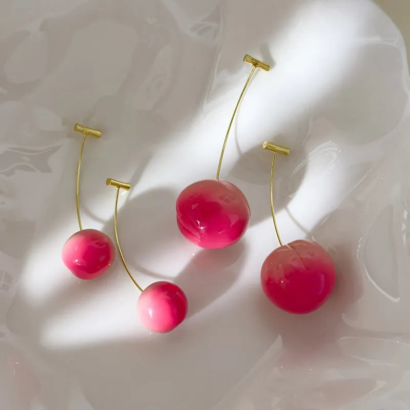 A pair of peach-shaped acrylic earrings on copper posts, shown in a choice of large or small sizes.