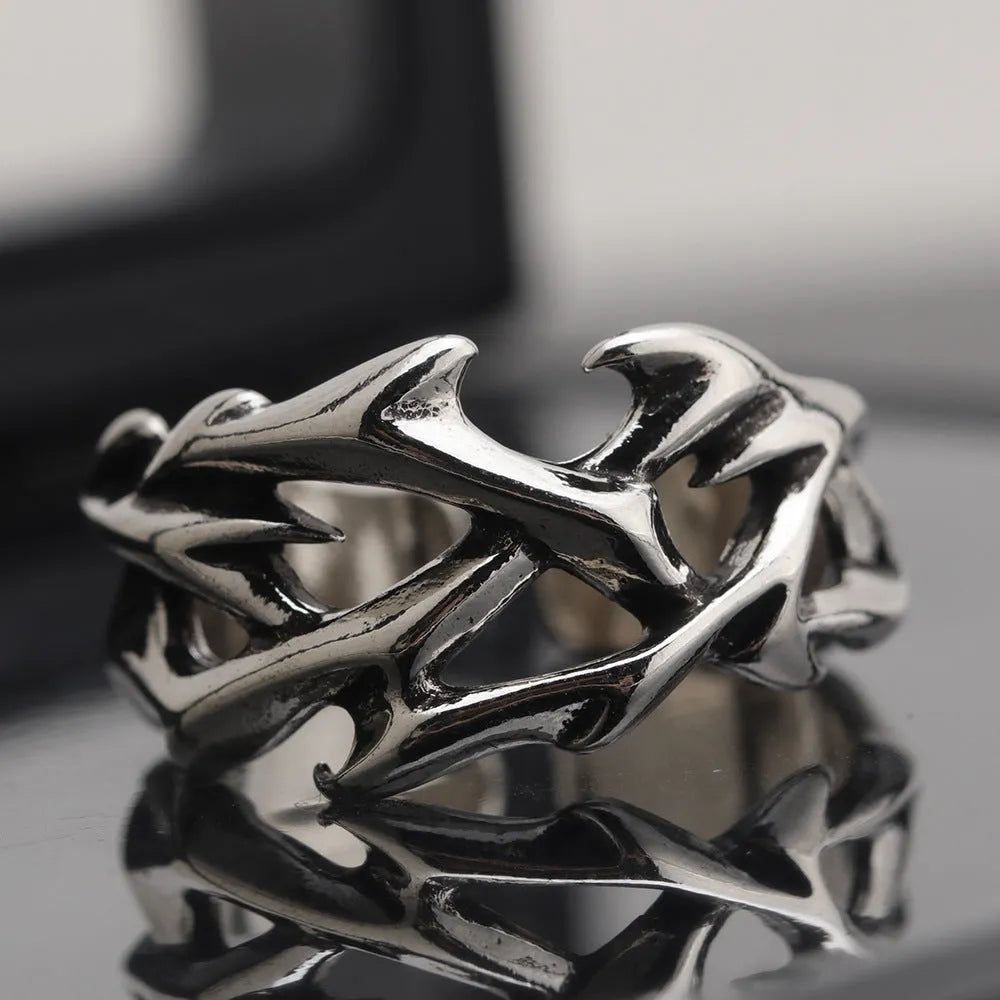 Copper geometric thorn flower ring with adjustable opening on a neutral background.