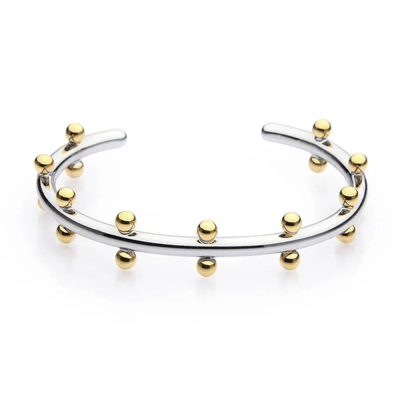 Stainless steel C-shaped bead with textured rivet detail and an alloy bracelet.