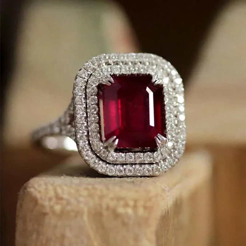 Women's copper square ring with red rhinestones, shown in a geometric princess cut design.