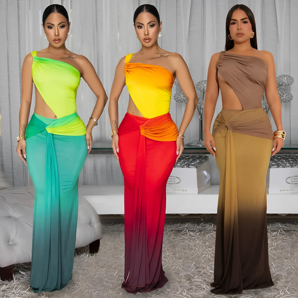 A woman wearing a long gradient colour dress with a cross-shoulder sleeveless design and high waist.