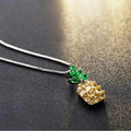 Women's silver tone necklace with a geometric pineapple and diamond motif pendant on a chain.
