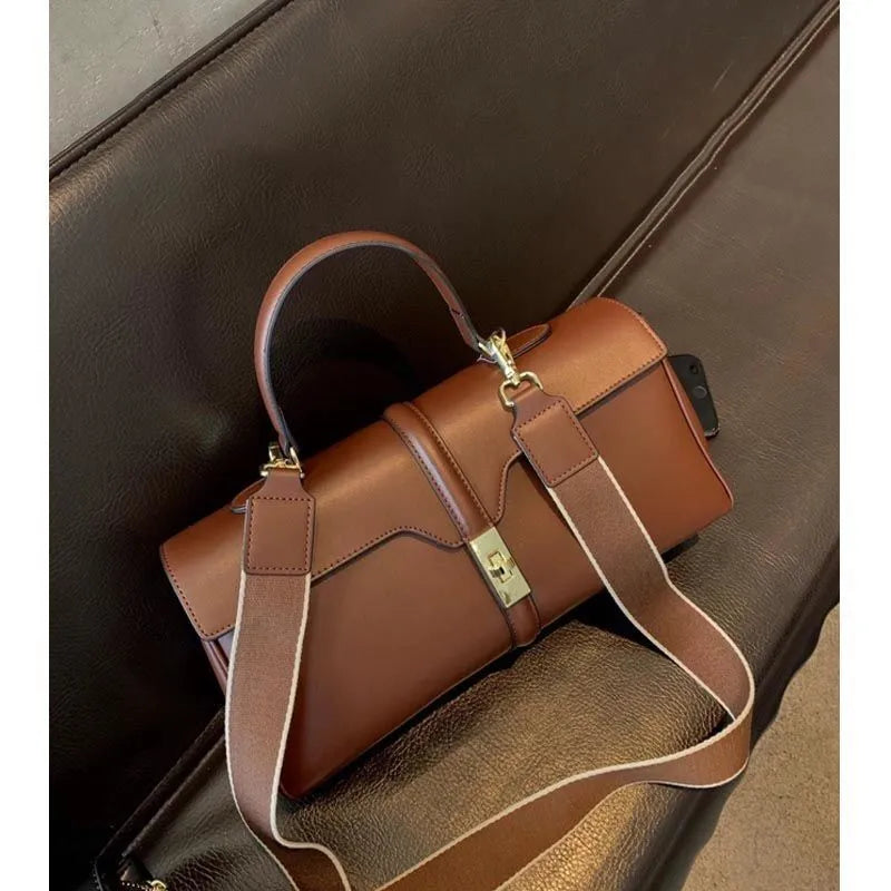 Genuine cowhide leather women's messenger bag in cylindrical suitcase shape with internal organisation compartments