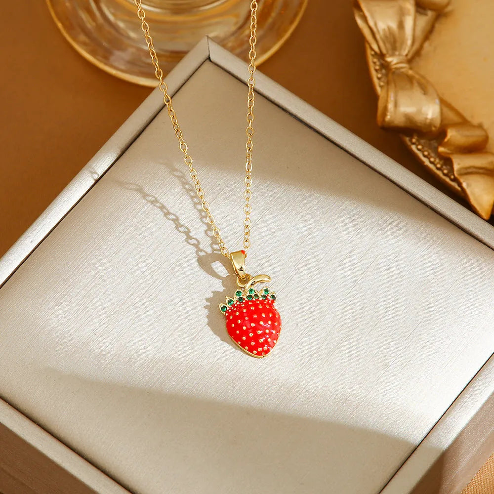 Golden pepper charm on an adjustable titanium steel necklace chain, laid flat.