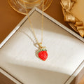 Golden pepper charm on an adjustable titanium steel necklace chain, laid flat.