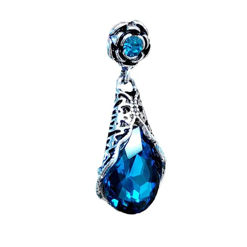 Retro peacock blue crystal water drop drop earrings on a light background