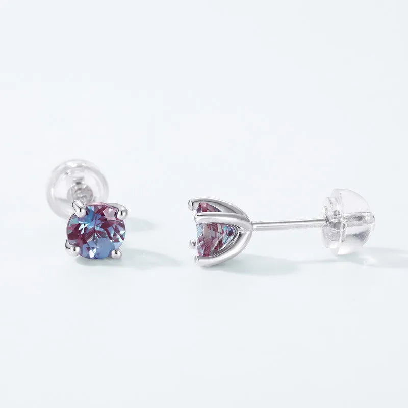 A pair of simple style silver ear studs with a round cultivated Alexandrite stone in a geometric setting.