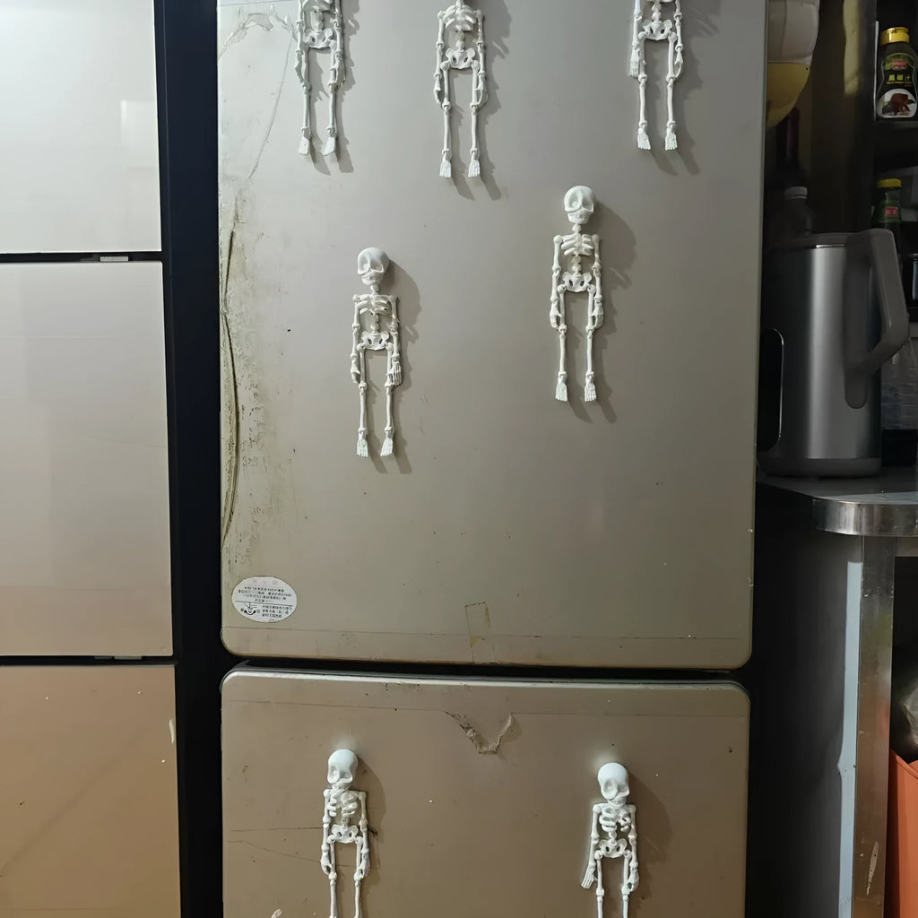 3D printed white skull refrigerator magnet with detailed model on a kitchen fridge.