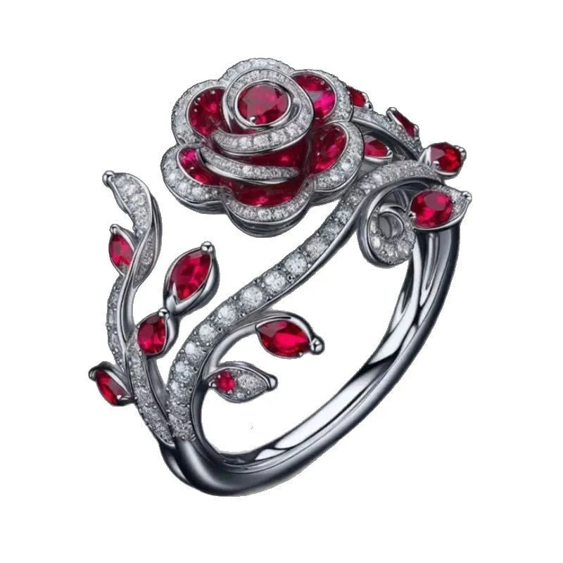 Silver ring with interwoven leaf pattern and red zircon stone