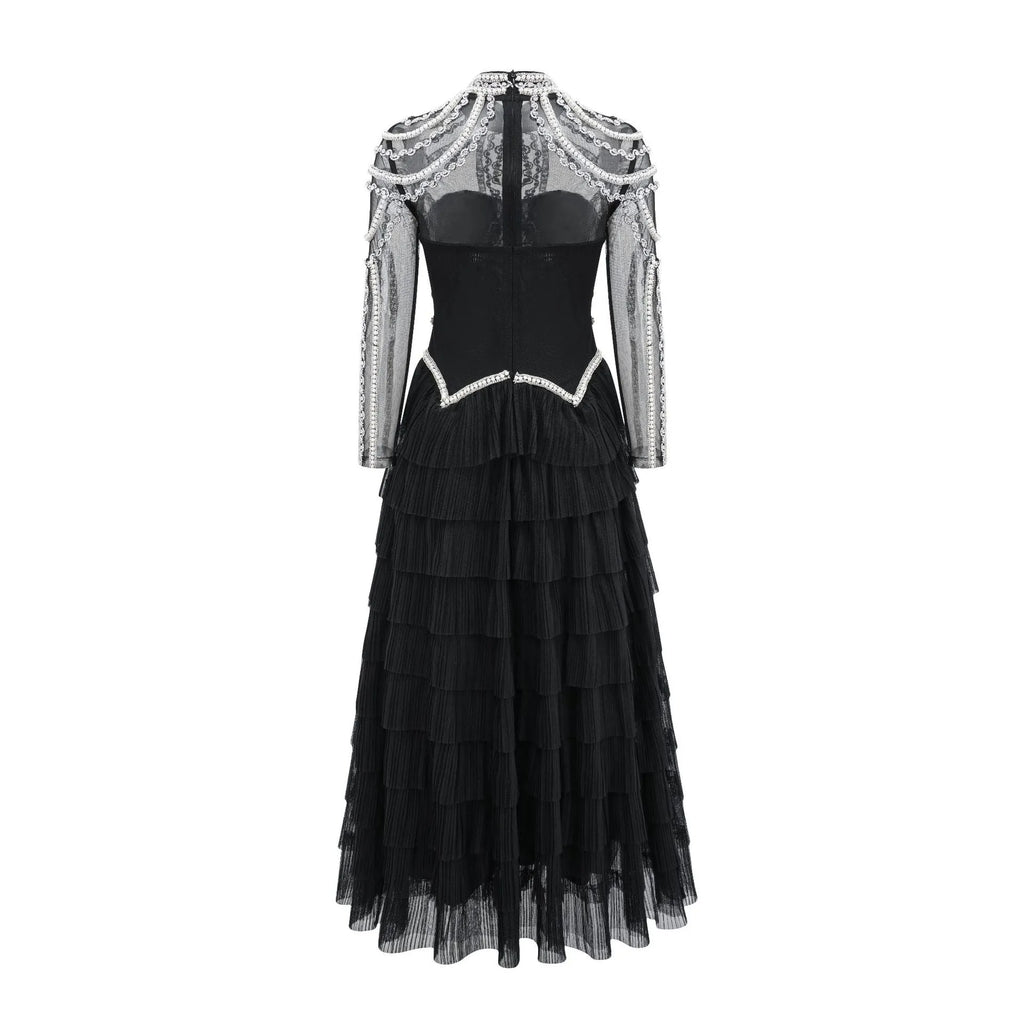 Women's black long sleeve beaded dress with a mid waist and long skirt.