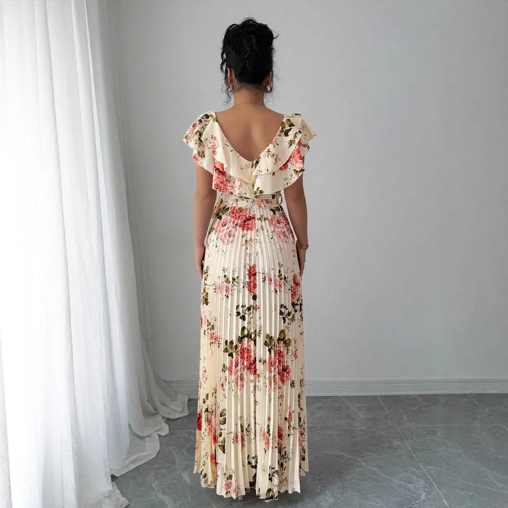 Apricot-coloured women's V-neck floral print dress with ruffled short sleeves and a long, pleated oversized swing skirt.