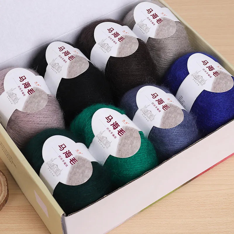 Hand-woven DIY mohair scarf kit with wool ball, shown in a selection of colours including beige, pink, and blue.