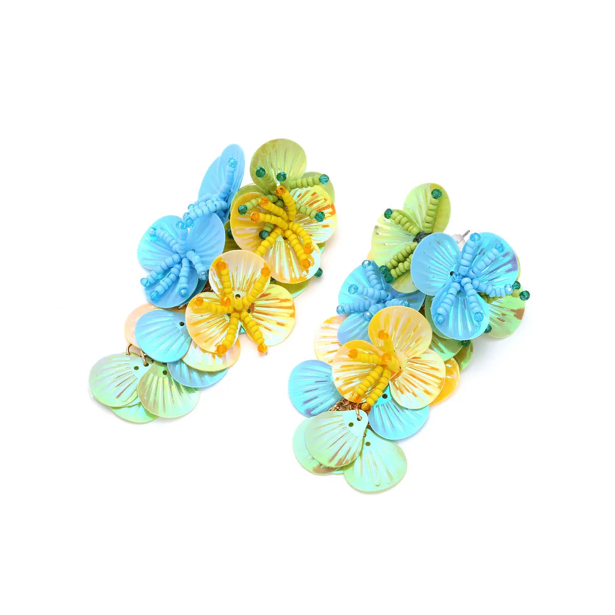 Colourful handmade bead and string flower earrings in exaggerated dopamine style on a purple background.