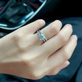 Silver Chinese-style couple's ring with dragon, phoenix, and heart design on an adjustable band.