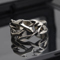 Copper geometric thorn flower ring with adjustable opening on a neutral background.