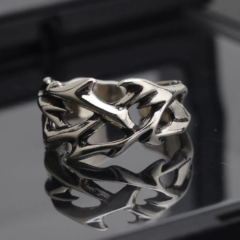 Copper geometric thorn flower ring with adjustable opening on a neutral background.