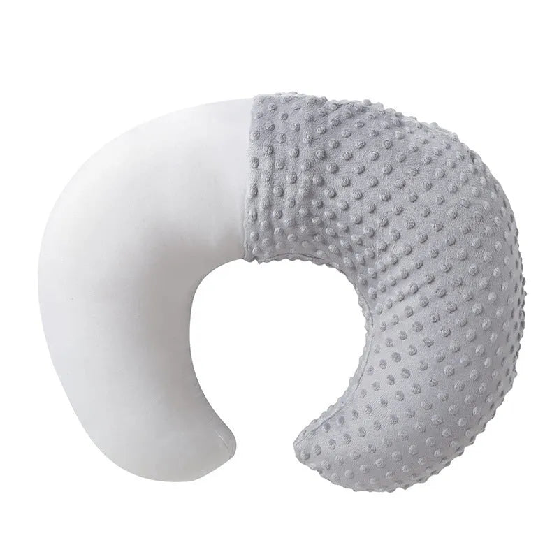 Grey nursing pillow with curved shape for feeding and spill prevention.