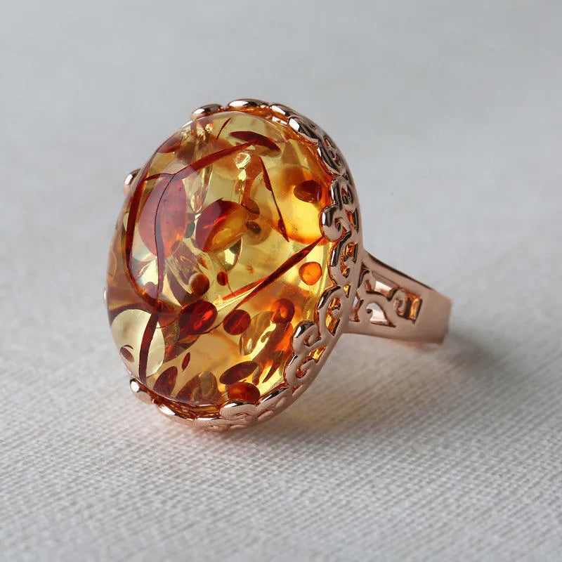 Unisex amber beeswax ring with carved design on an alloy band in New Amber Type A colour.