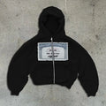 Black loose-fit hoodie jacket with a front zipper and zippered kangaroo pocket on a person.