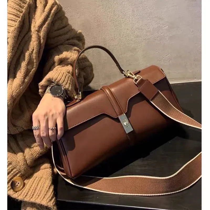 Genuine cowhide leather women's messenger bag in cylindrical suitcase shape with internal organisation compartments