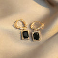 Close-up of women's black zircon geometric earrings made from solid copper with a quadrilateral design.
