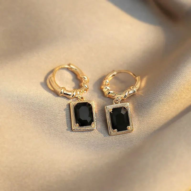 Close-up of women's black zircon geometric earrings made from solid copper with a quadrilateral design.