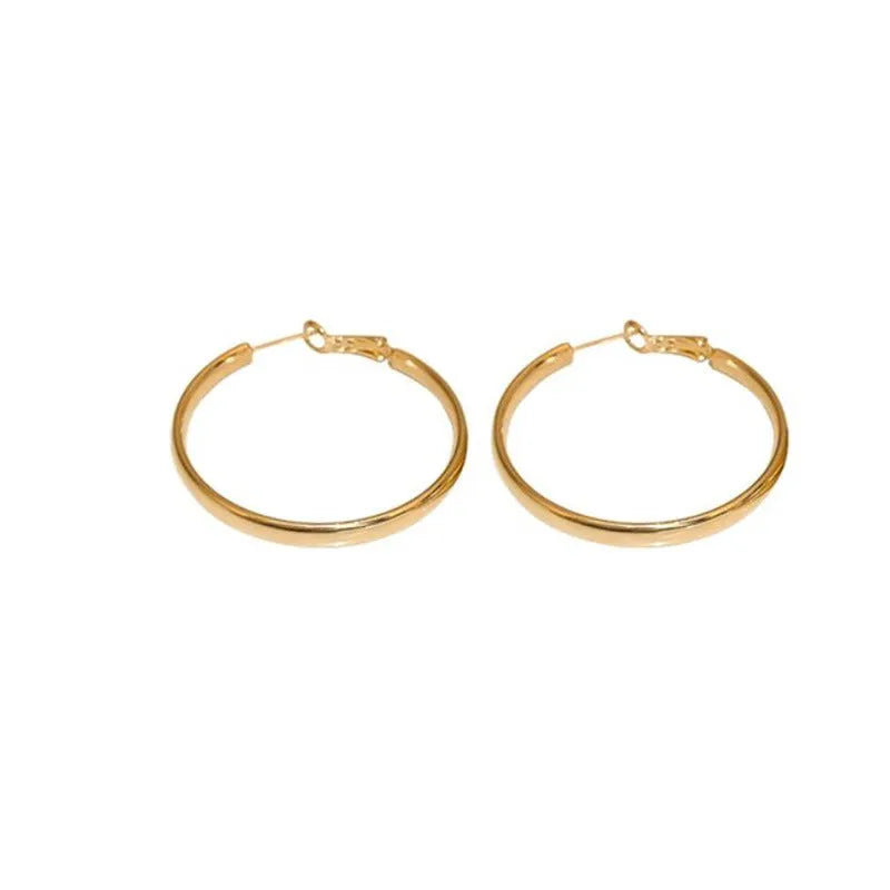A pair of gold metal circle hoop earrings with a 40mm diameter on a plain background.