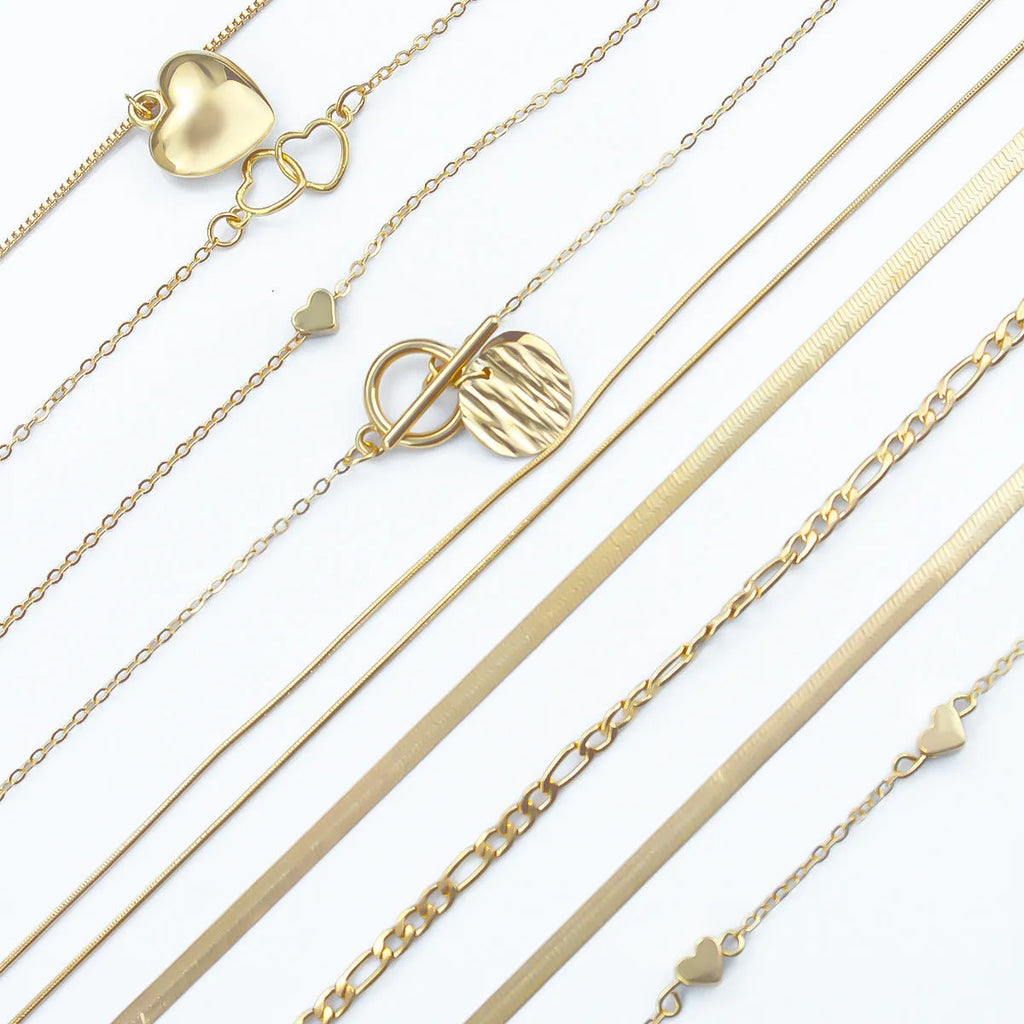 Gold tone women's necklace set with 10 ornamental pieces on snake bone chain