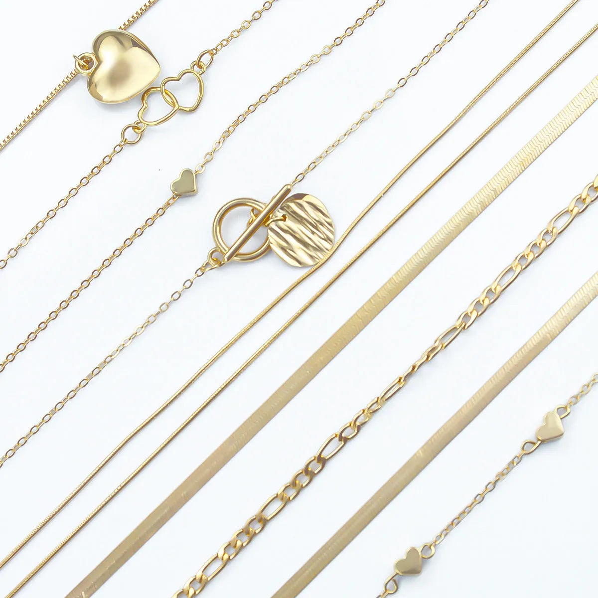 Gold tone women's necklace set with 10 ornamental pieces on snake bone chain