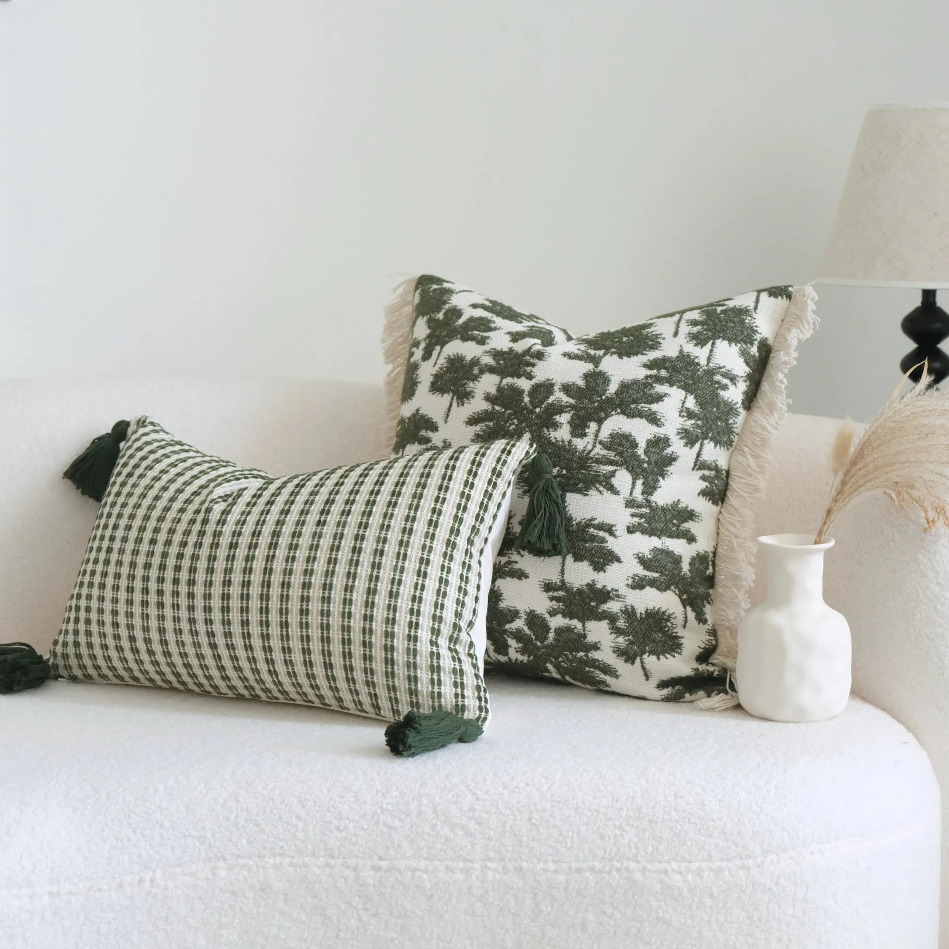Green cotton and linen hotel pillow with decorative tassels and botanical patterns, shown with pillowcase and silk floss core.