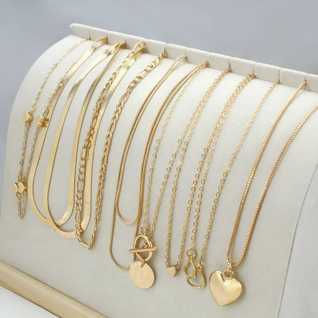 Gold tone women's necklace set with 10 ornamental pieces on snake bone chain