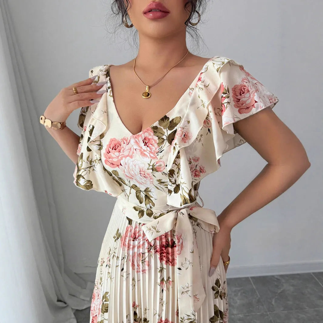 Apricot-coloured women's V-neck floral print dress with ruffled short sleeves and a long, pleated oversized swing skirt.