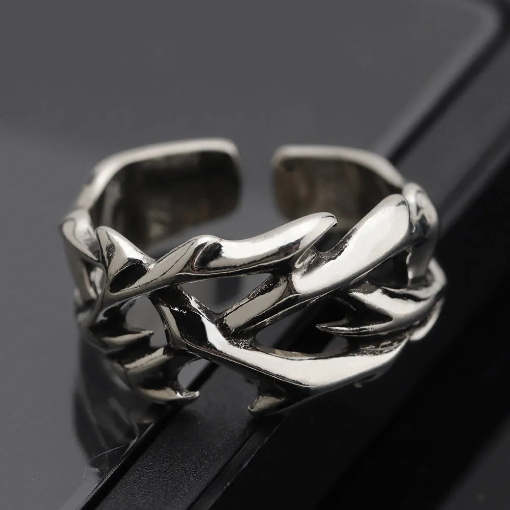 Copper geometric thorn flower ring with adjustable opening on a neutral background.