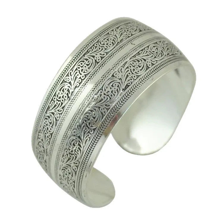 Ethnic carved open Miao silver bracelet with Roman patterns showing elephant and turtle motifs