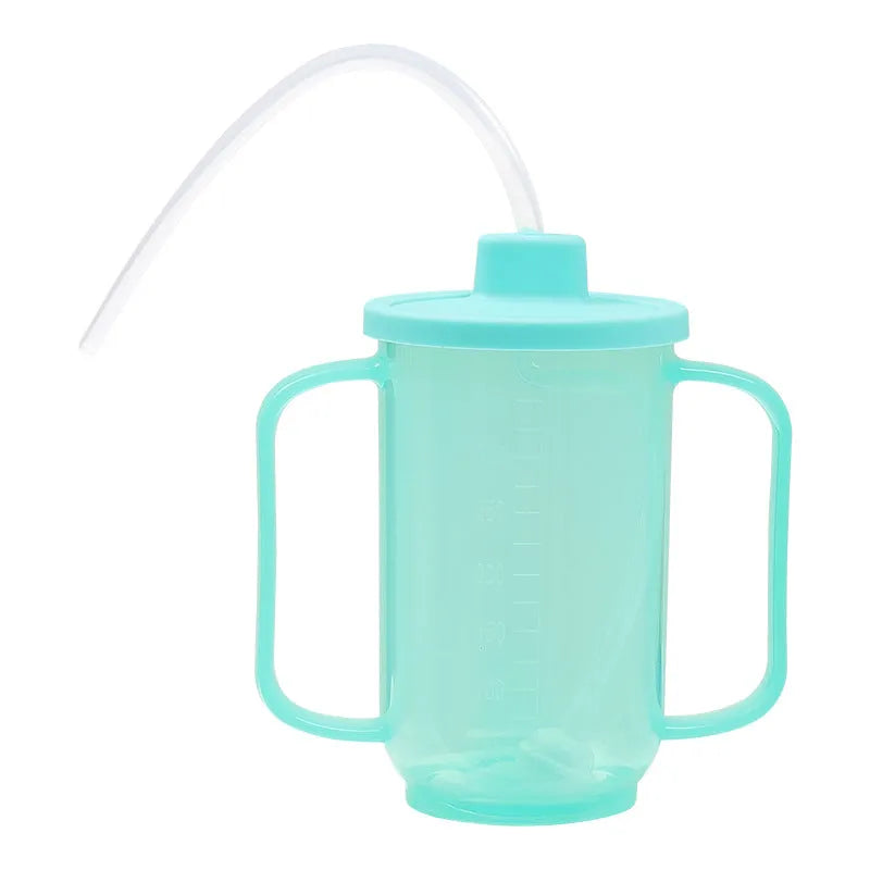Oblique mouth choke-proof drinking cup with handle and lid, shown in bed care setting.