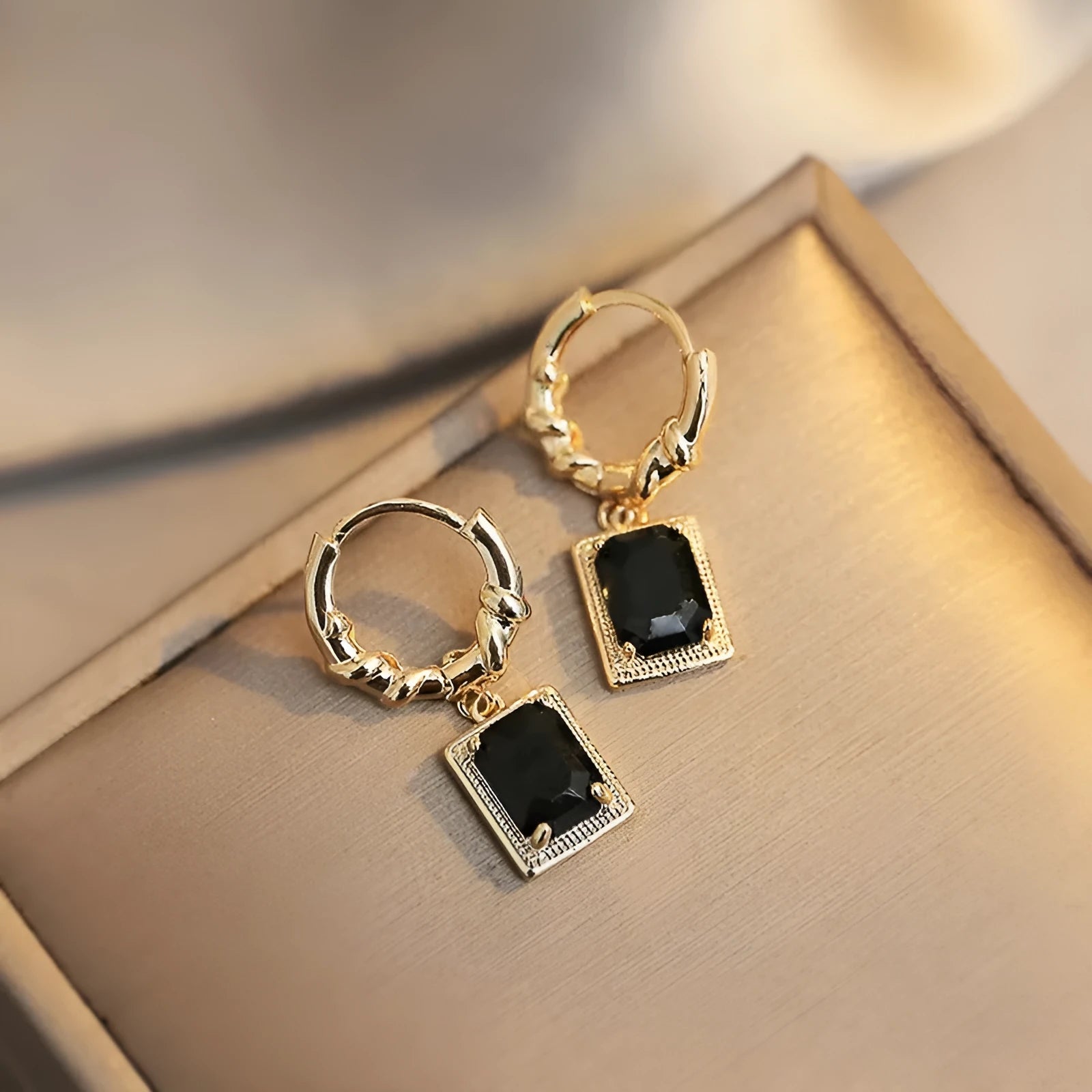 Close-up of women's black zircon geometric earrings made from solid copper with a quadrilateral design.