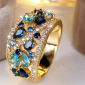 Round hollow women's fashion ring in copper, shown in platinum white and gold blue colour options.