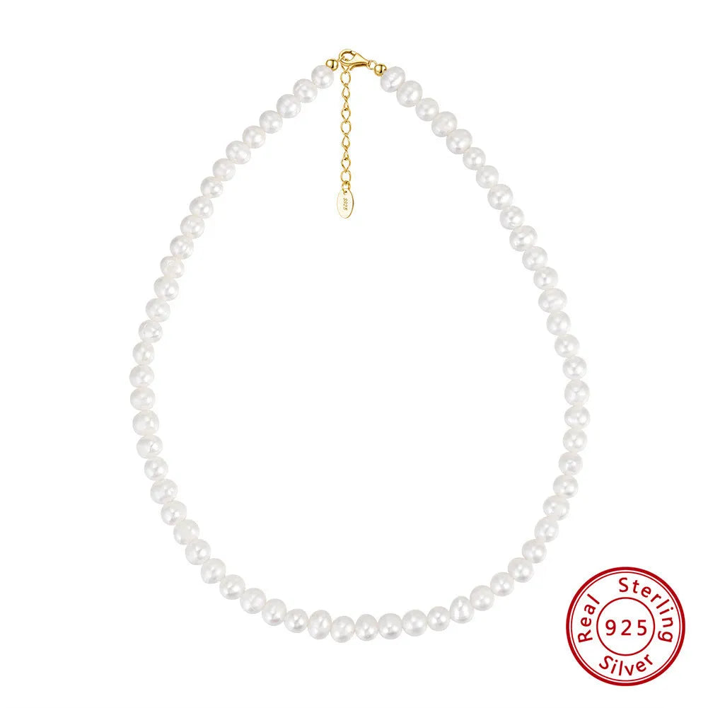 Close-up of a women's adjustable silver necklace with a natural freshwater pearl centrepiece.