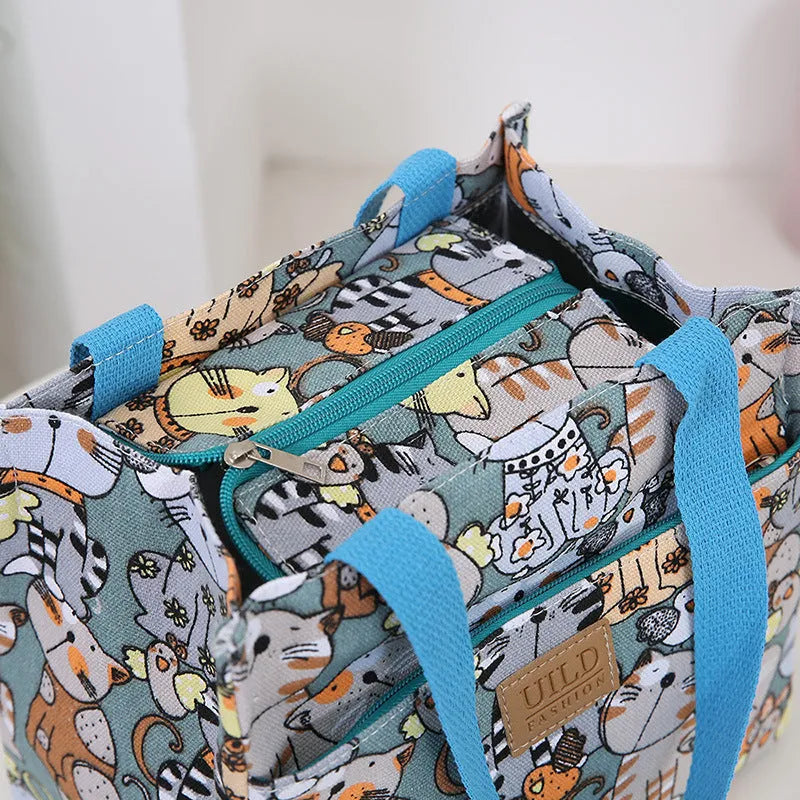 Women's large printed canvas tote bag with aluminium hardware in a horizontal square shape.
