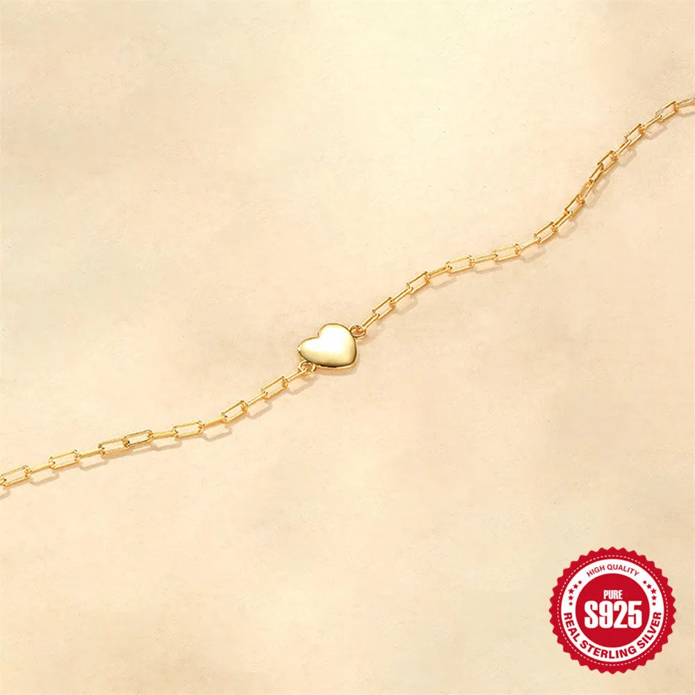 S925 sterling silver bracelet with heart charm and clip chain clasp in gold tone