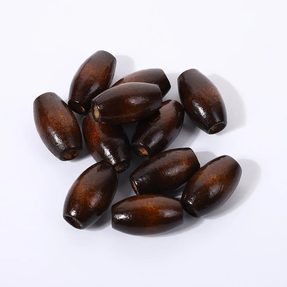 Dark coffee coloured oval wooden bead with an M-shaped raised design on a white background.
