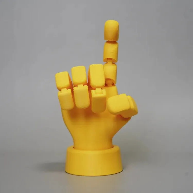 Yellow articulated hand prop with movable finger joints on a white background.