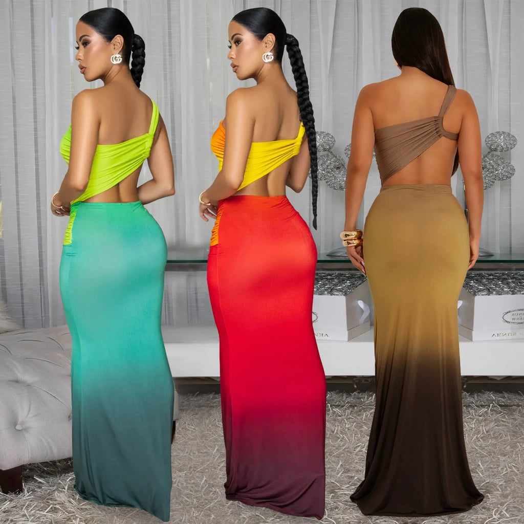 A woman wearing a long gradient colour dress with a cross-shoulder sleeveless design and high waist.
