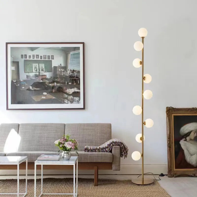 Tall minimalist Nordic floor lamp with wrought iron stand, glass details, and a marble foundation base.