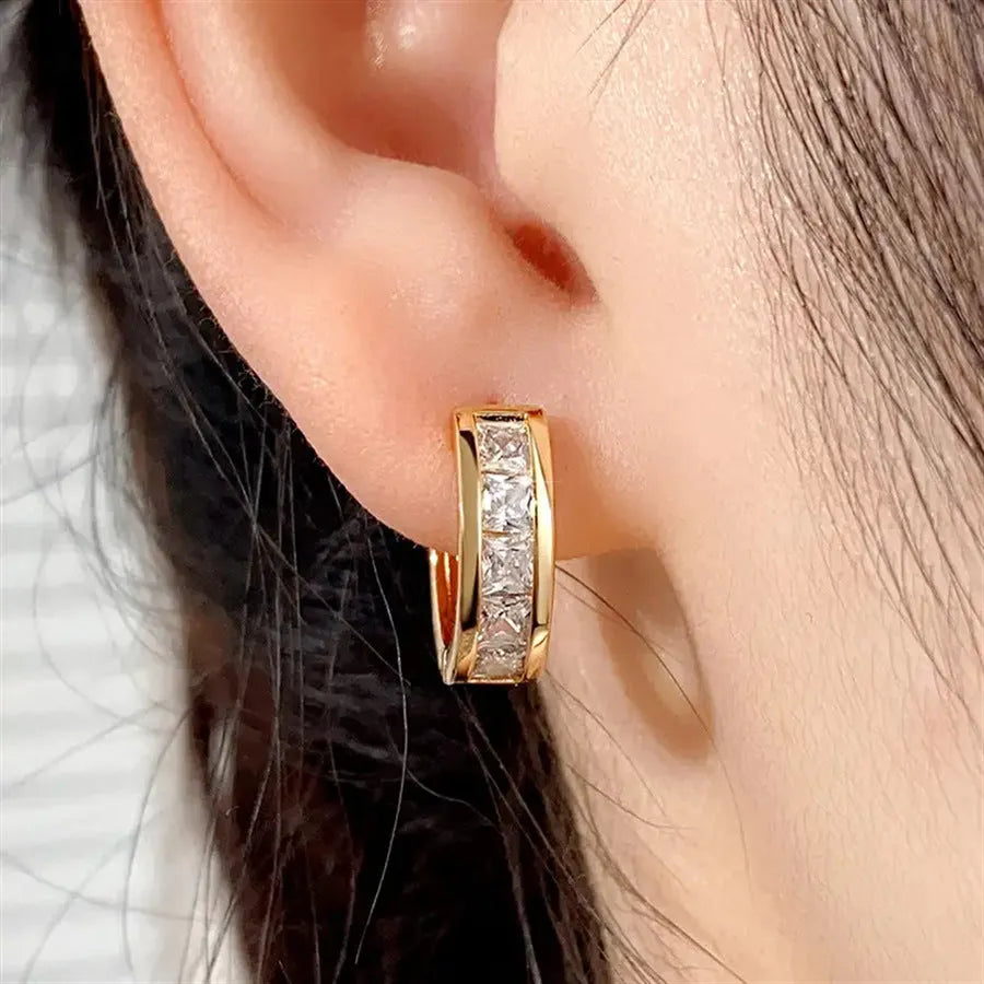 A pair of geometric quadrilateral fashion earrings for women in a gold colour finish.