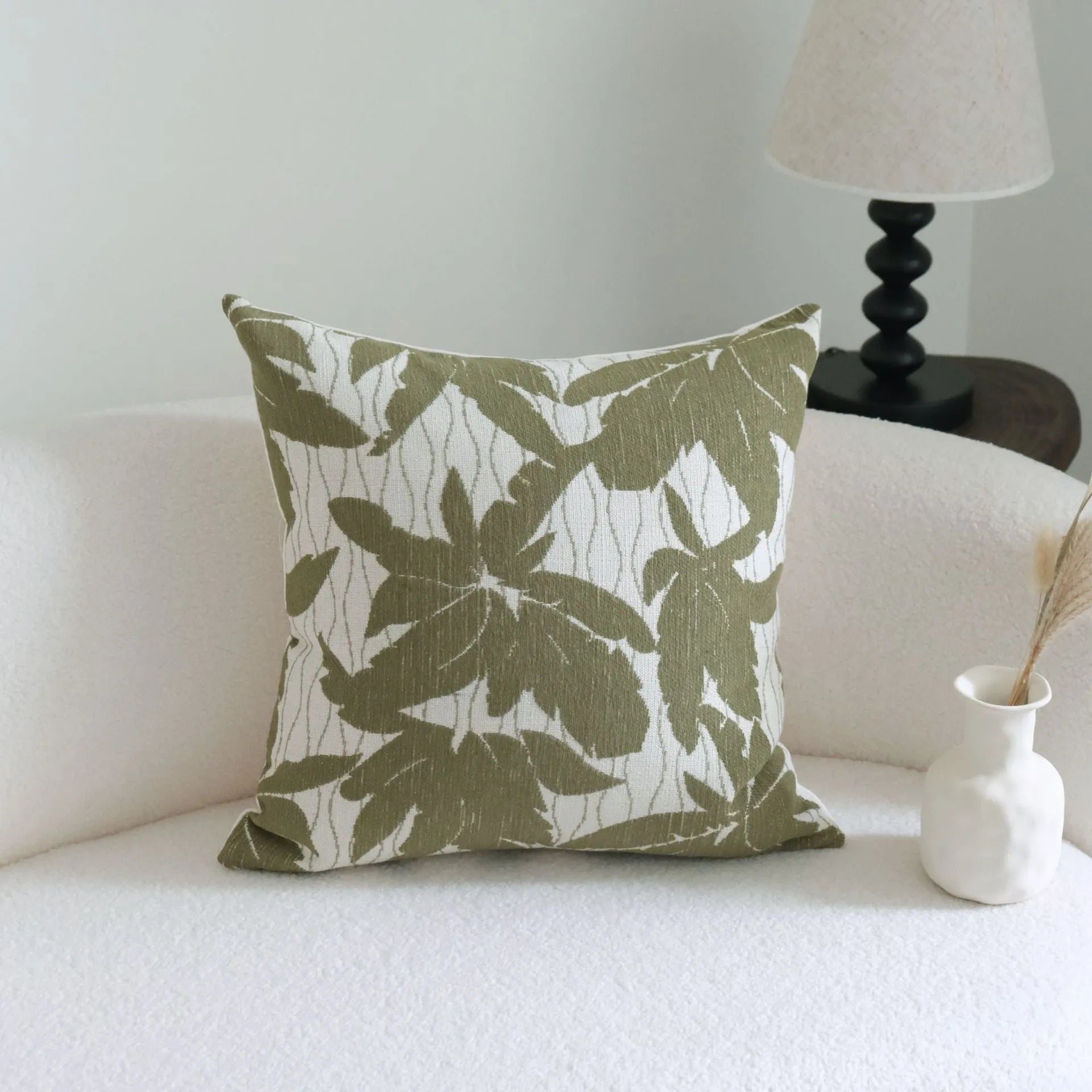 Green cotton and linen hotel pillow with decorative tassels and botanical patterns, shown with pillowcase and silk floss core.