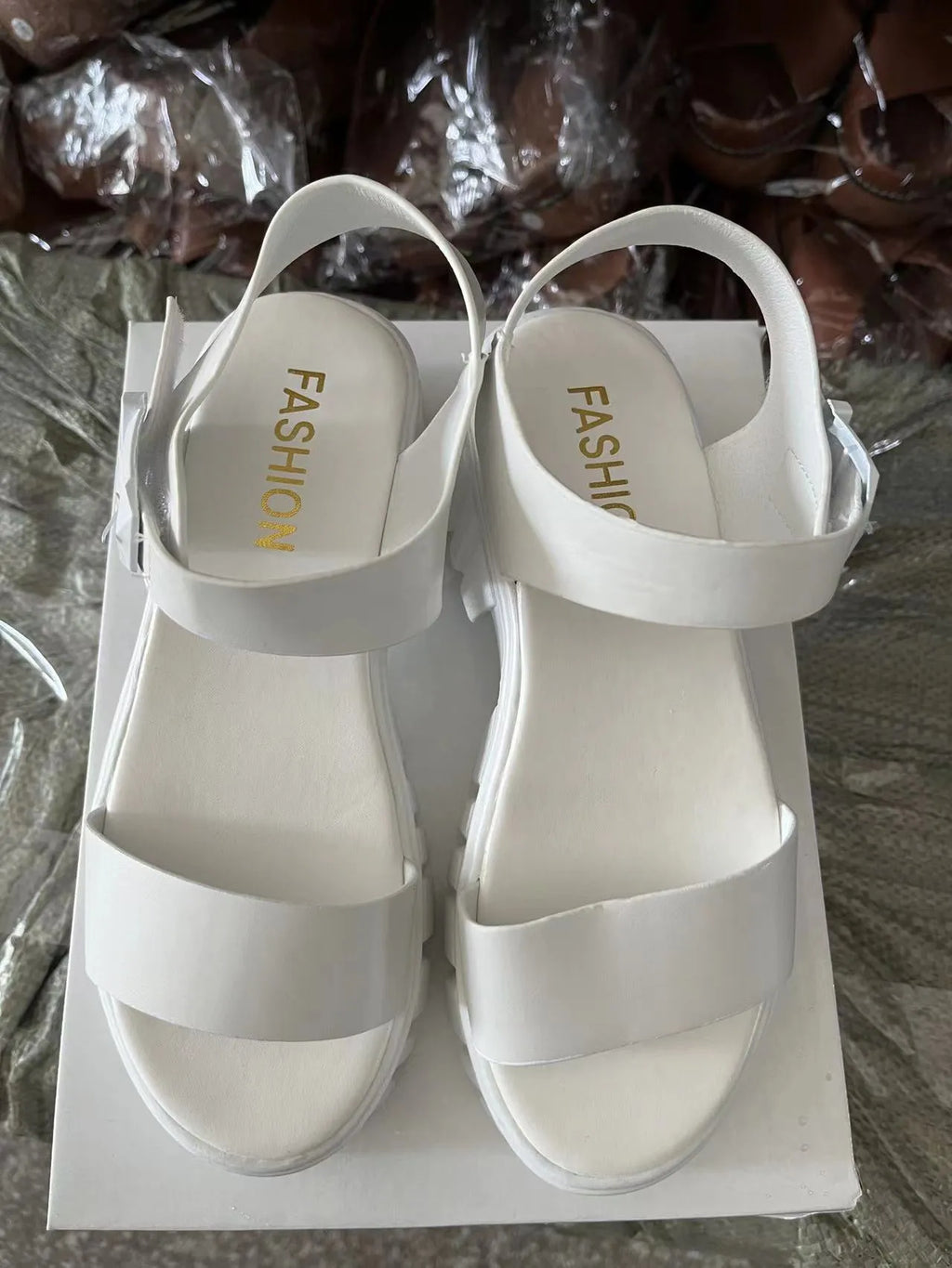 Women's beige peep toe platform sandals with an ankle-strap buckle on a white background.
