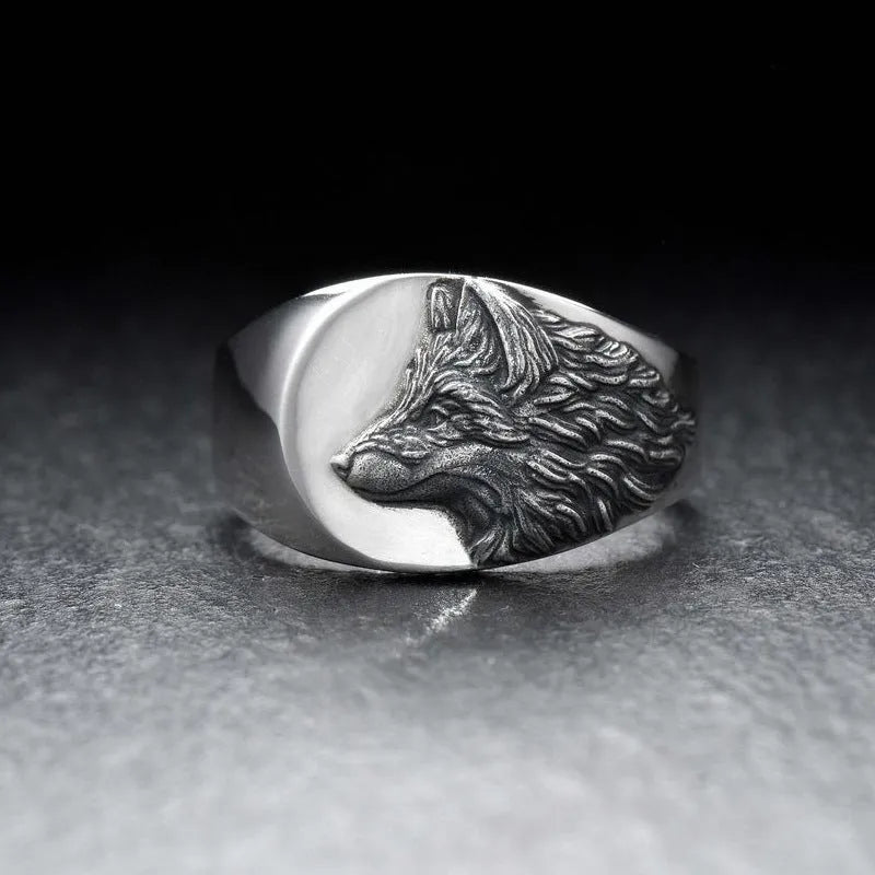 Men's silver geometric wolf head alloy ring on a black background, showing side and top views.